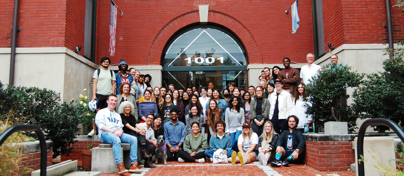 Students and faculty posed for a group photo at the front entrance of 1001 Prince Street