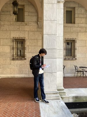 Luke Des Jardins sketching in the courtyard of the Boston Public Library.