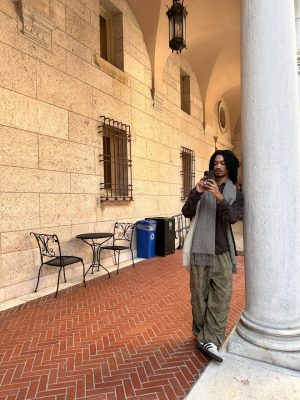 Isaiah Eneliko taking a photo in the courtyard of the Boston Public Library - photo by Olivia Labbate.